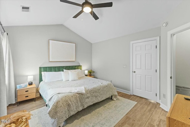 bedroom featuring vaulted ceiling, visible vents, ceiling fan, and wood finished floors