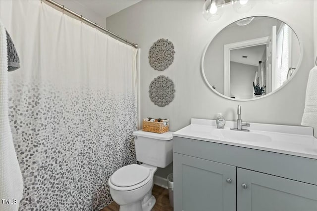 bathroom with a shower with shower curtain, toilet, vanity, and wood finished floors