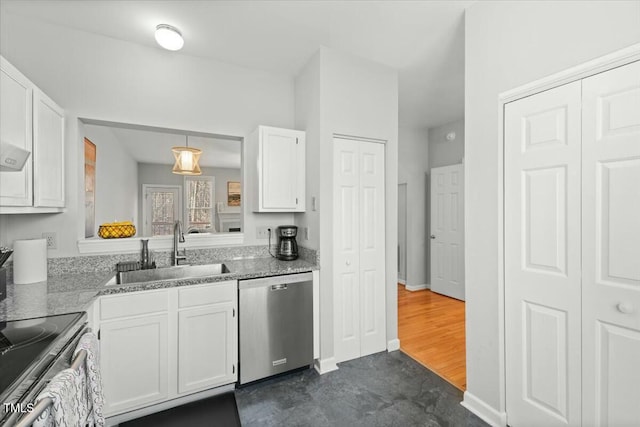 kitchen with a sink, light stone counters, white cabinetry, stainless steel appliances, and baseboards