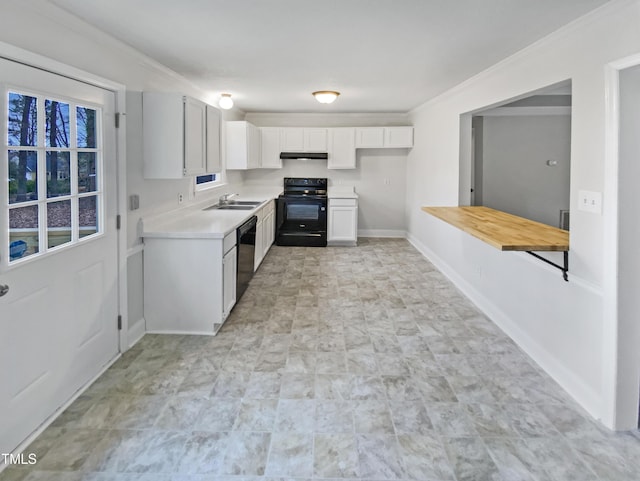 kitchen featuring baseboards, a sink, black appliances, white cabinets, and light countertops