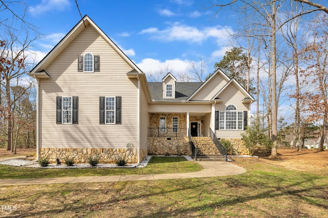 traditional-style home with covered porch and a front yard