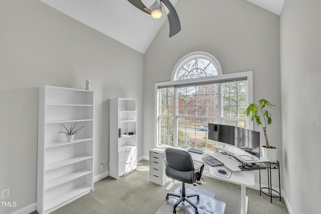 office space featuring carpet flooring, baseboards, a ceiling fan, and high vaulted ceiling