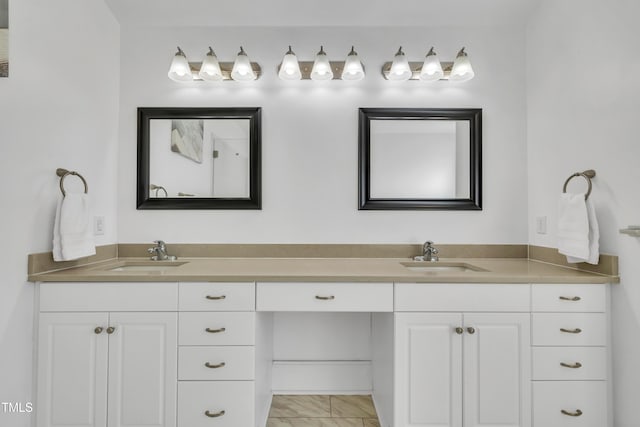 bathroom with double vanity, marble finish floor, and a sink