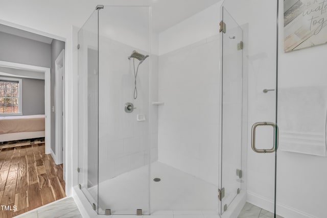 bathroom with ensuite bath, wood finished floors, and a shower stall