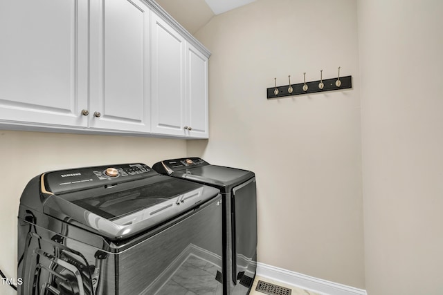 laundry room featuring visible vents, marble finish floor, washing machine and dryer, cabinet space, and baseboards