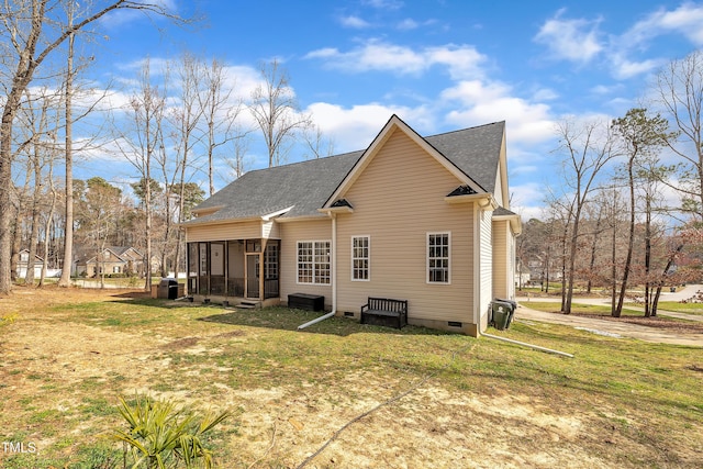 rear view of property with crawl space, a lawn, roof with shingles, and a sunroom