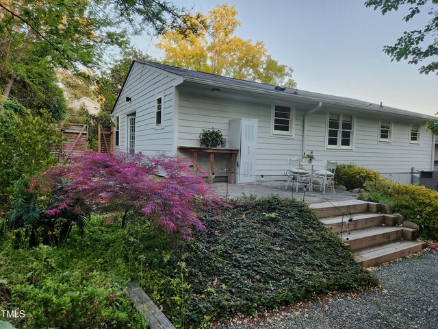 back of house featuring central AC unit and a patio