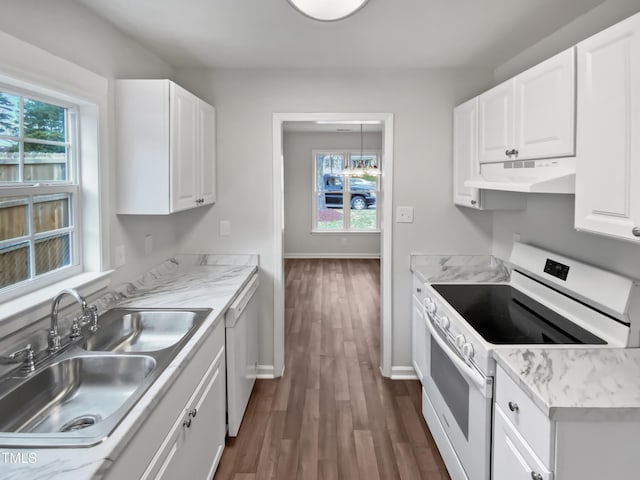 kitchen with white appliances, dark wood finished floors, a sink, white cabinets, and under cabinet range hood