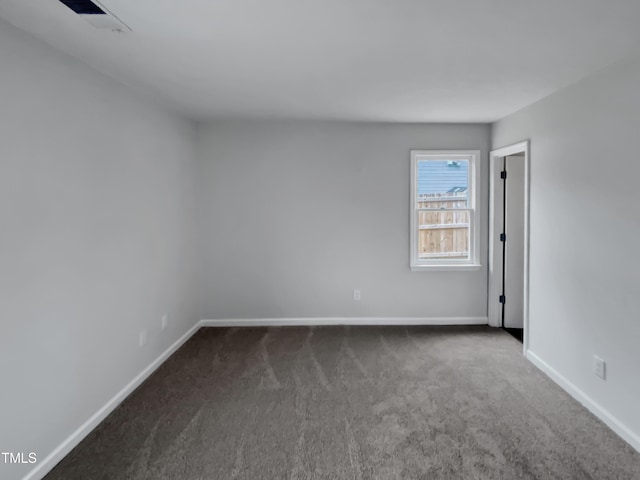 carpeted spare room with baseboards and visible vents