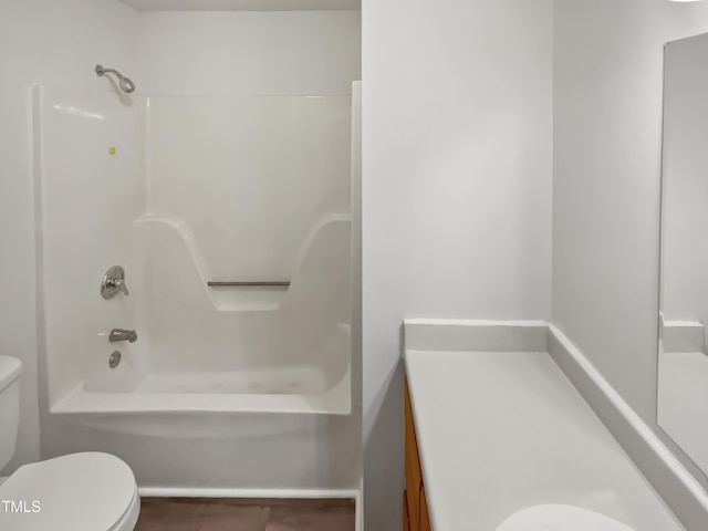 bathroom featuring bathtub / shower combination, toilet, and vanity