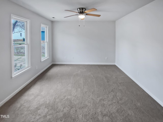 empty room featuring visible vents, baseboards, ceiling fan, and carpet flooring