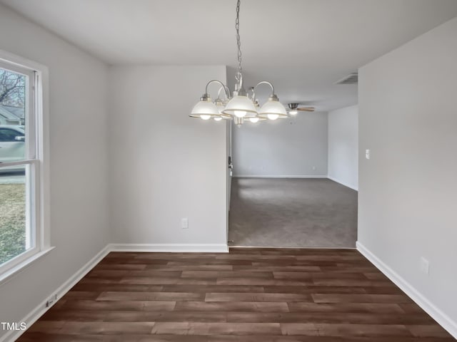 unfurnished room featuring visible vents, wood finished floors, baseboards, and a chandelier