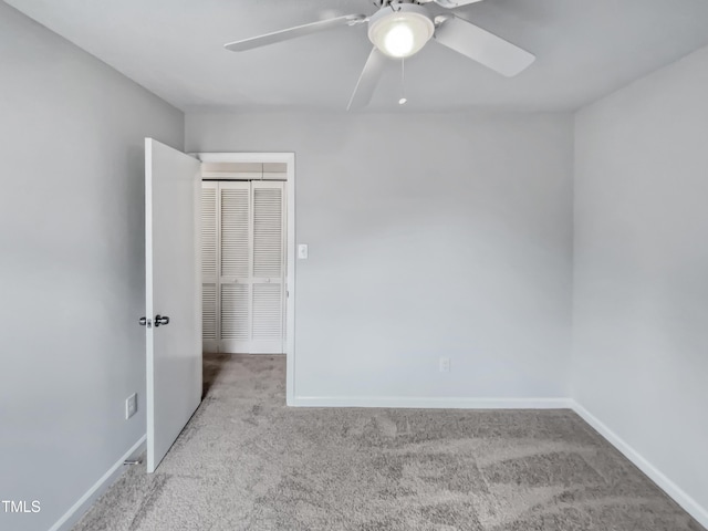 unfurnished bedroom with carpet flooring, baseboards, and ceiling fan