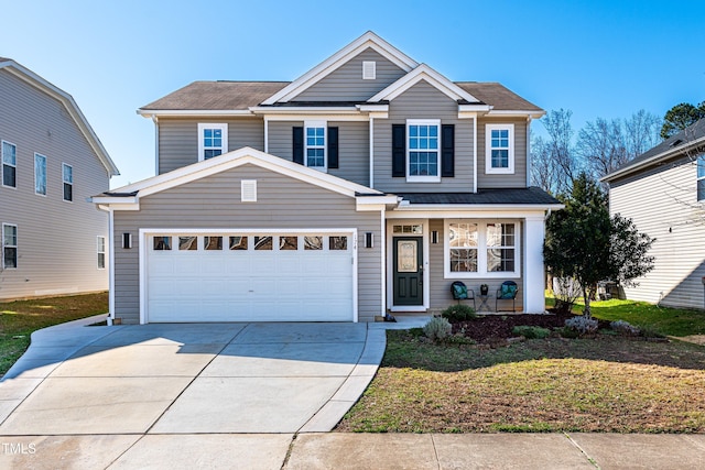 traditional-style house featuring a garage, a front yard, and driveway