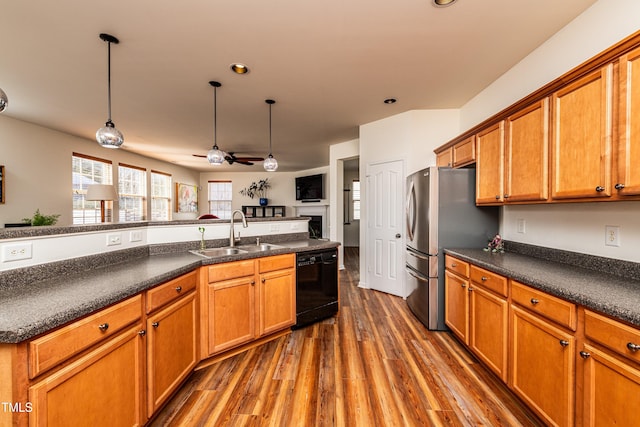 kitchen featuring a sink, dark wood-type flooring, black dishwasher, dark countertops, and brown cabinets