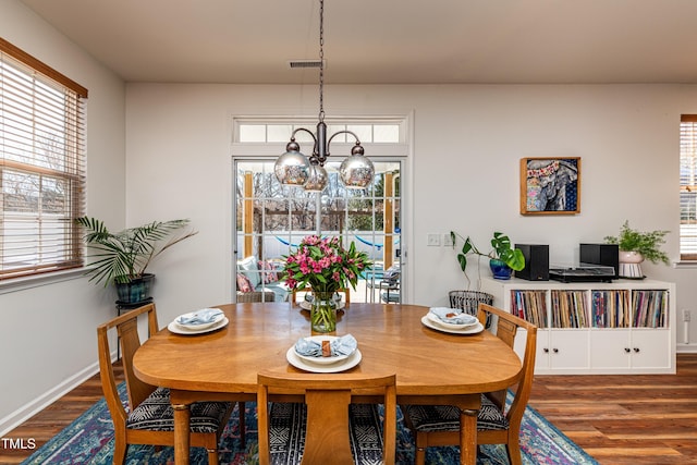 dining space featuring wood finished floors, visible vents, and a wealth of natural light