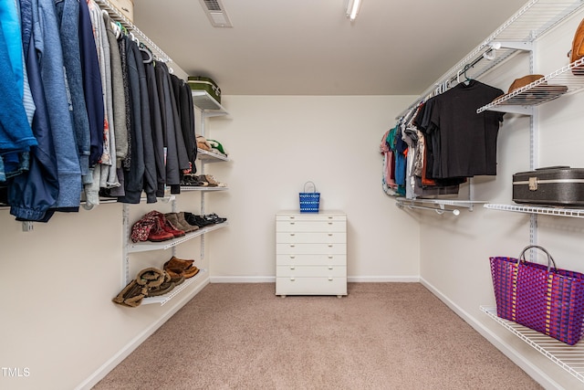 walk in closet featuring carpet flooring and visible vents