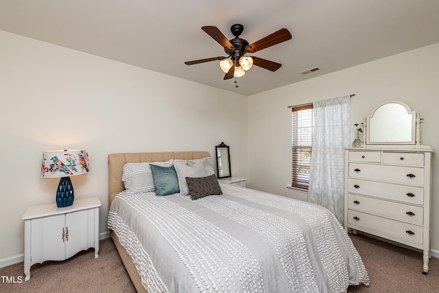 bedroom with baseboards, light colored carpet, visible vents, and ceiling fan