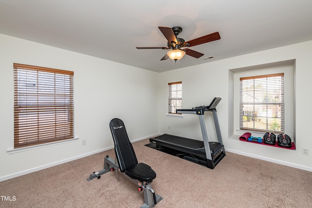 workout room featuring visible vents, carpet floors, baseboards, and ceiling fan