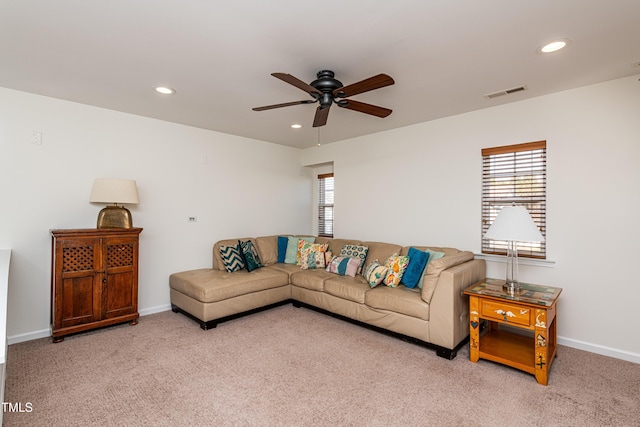 living room featuring light carpet, visible vents, recessed lighting, and baseboards