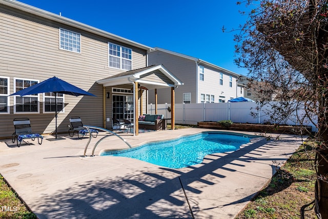 view of swimming pool featuring a patio area, a fenced in pool, an outdoor hangout area, and fence