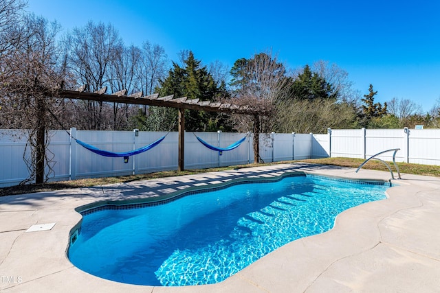 view of swimming pool featuring a patio area, a fenced in pool, and a fenced backyard