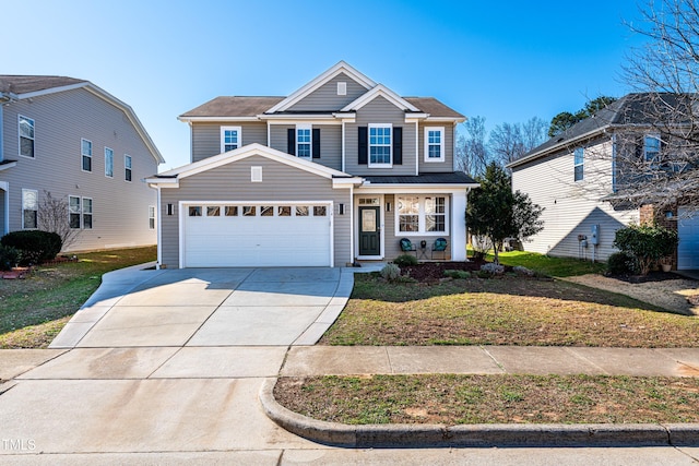 traditional-style home featuring concrete driveway, a garage, and a front yard