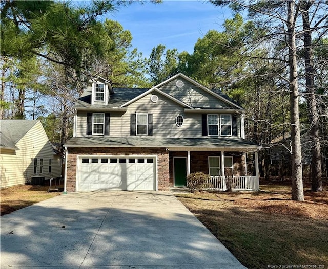 view of front of property with covered porch, concrete driveway, and a garage