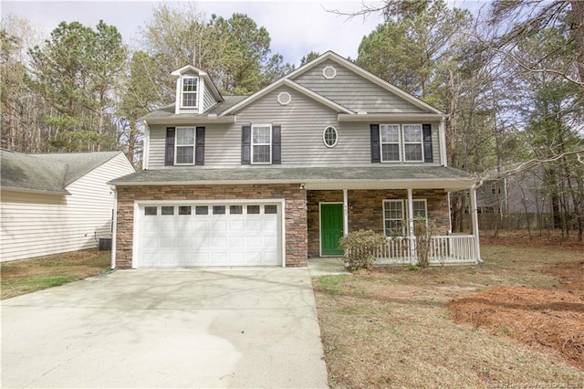 440 Moss Pink Dr, Vass, NC 28394 - view of front of property featuring covered porch, stone siding, driveway, and a garage