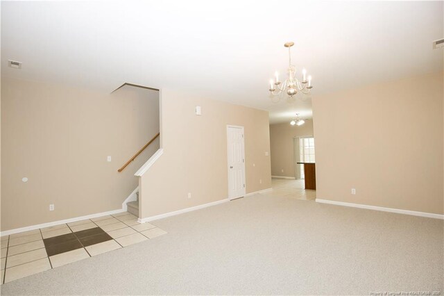 440 Moss Pink Dr, Vass, NC 28394 - unfurnished living room with light colored carpet, a notable chandelier, stairway, and light tile patterned floors