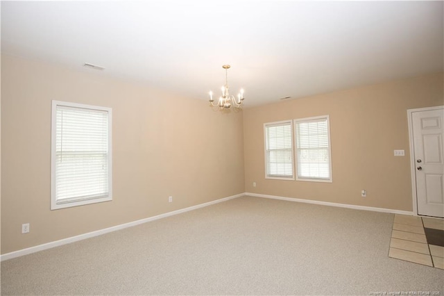 440 Moss Pink Dr, Vass, NC 28394 - spare room featuring baseboards, visible vents, an inviting chandelier, and light carpet
