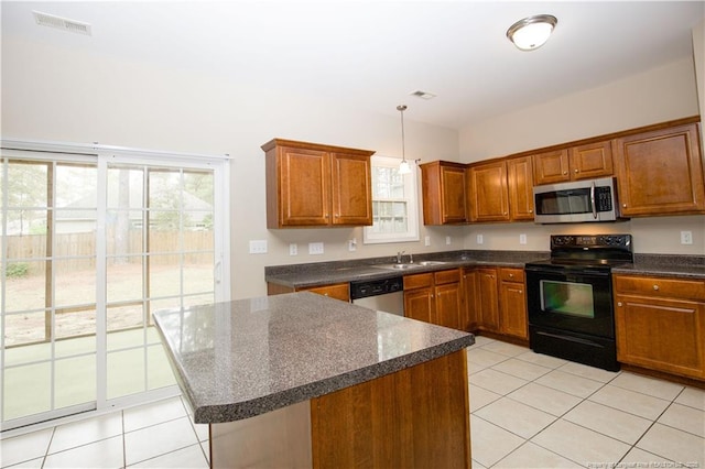 440 Moss Pink Dr, Vass, NC 28394 - kitchen with light tile patterned flooring, stainless steel appliances, brown cabinets, and visible vents