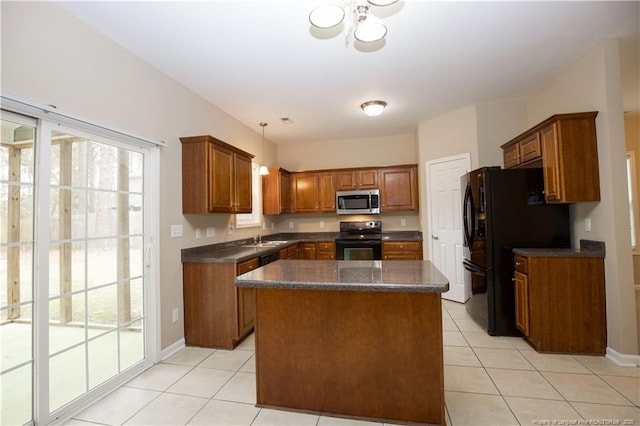440 Moss Pink Dr, Vass, NC 28394 - kitchen with light tile patterned floors, a kitchen island, black appliances, and brown cabinets