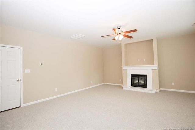 440 Moss Pink Dr, Vass, NC 28394 - unfurnished living room featuring light colored carpet, a fireplace with raised hearth, ceiling fan, and baseboards