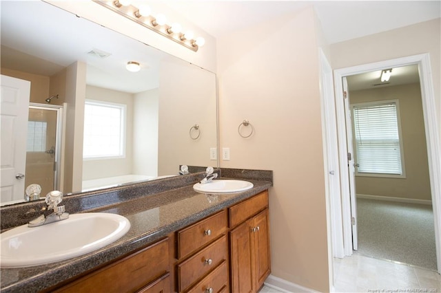 440 Moss Pink Dr, Vass, NC 28394 - bathroom with a shower, double vanity, a sink, and visible vents