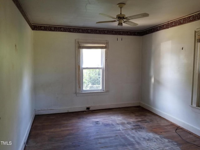 empty room with baseboards, a ceiling fan, hardwood / wood-style floors, and crown molding