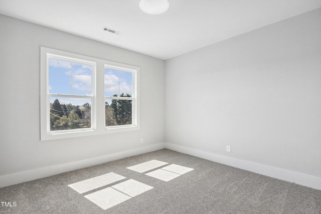 carpeted empty room with visible vents and baseboards