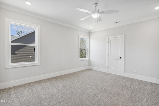 carpeted spare room with ceiling fan, baseboards, ornamental molding, and recessed lighting