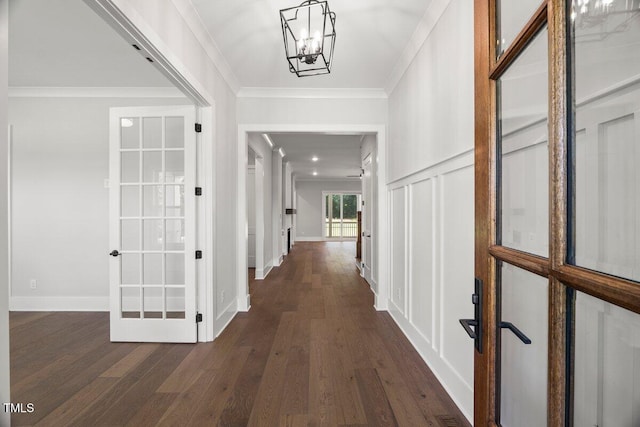 9004 Penny Rd, Raleigh, NC 27606 - corridor featuring dark wood-type flooring, crown molding, a chandelier, and french doors