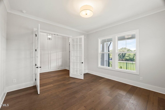9004 Penny Rd, Raleigh, NC 27606 - unfurnished bedroom featuring french doors, dark wood-style floors, crown molding, and a closet