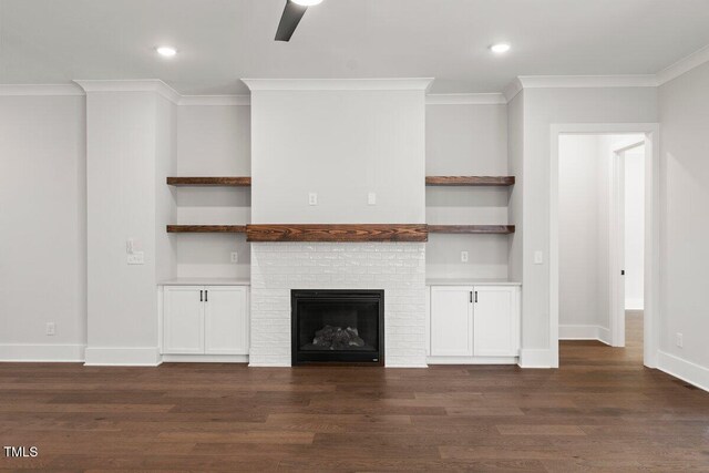 9004 Penny Rd, Raleigh, NC 27606 - unfurnished living room with crown molding, dark wood finished floors, recessed lighting, and a brick fireplace
