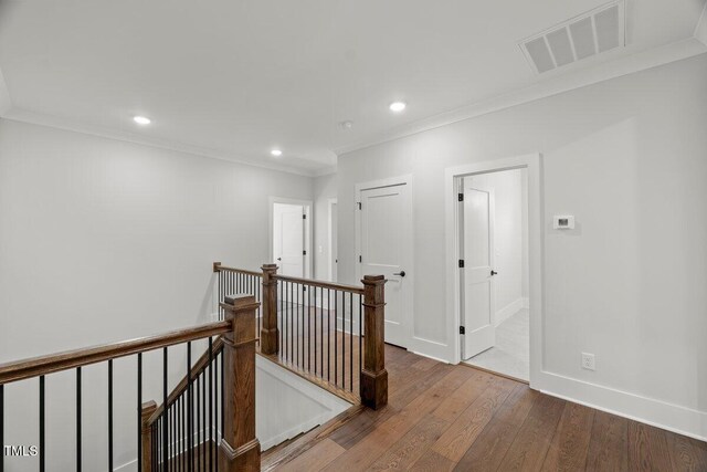9004 Penny Rd, Raleigh, NC 27606 - hallway featuring an upstairs landing, crown molding, wood finished floors, and recessed lighting