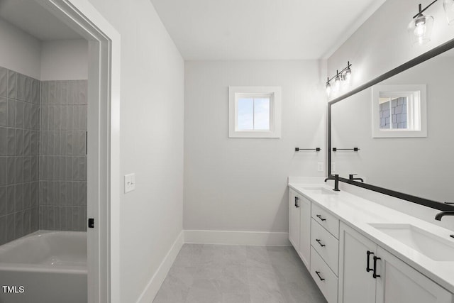 9004 Penny Rd, Raleigh, NC 27606 - bathroom featuring double vanity, shower / bathtub combination, and marble look tile flooring