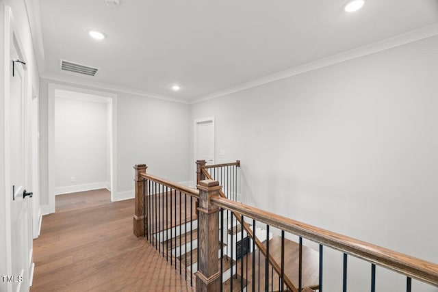 9004 Penny Rd, Raleigh, NC 27606 - corridor featuring an upstairs landing, wood finished floors, recessed lighting, and crown molding