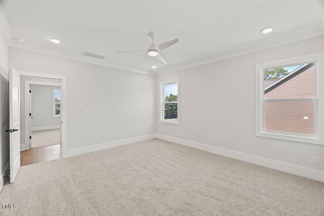 9004 Penny Rd, Raleigh, NC 27606 - empty room featuring carpet, healthy amount of natural light, ornamental molding, a ceiling fan, and recessed lighting