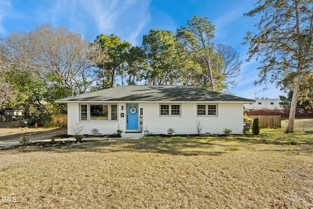 ranch-style home with brick siding, a front yard, and fence