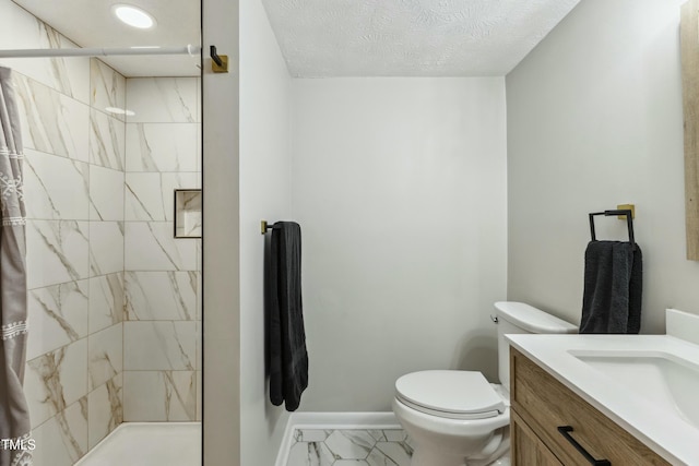 full bathroom with toilet, marble finish floor, a stall shower, a textured ceiling, and vanity