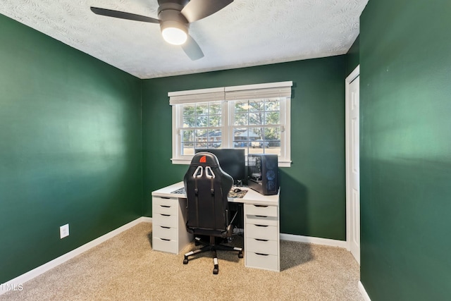 office space with light colored carpet, baseboards, and a textured ceiling