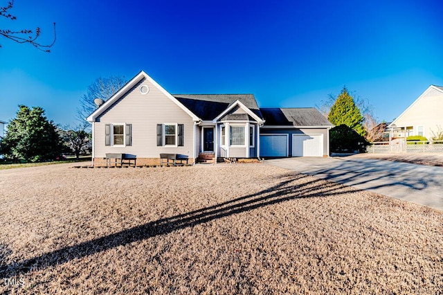 single story home with driveway, an attached garage, and fence