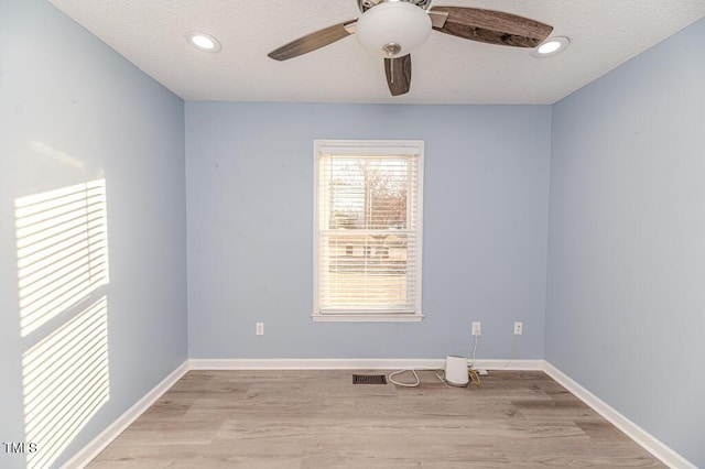 unfurnished room featuring light wood-type flooring, baseboards, and ceiling fan